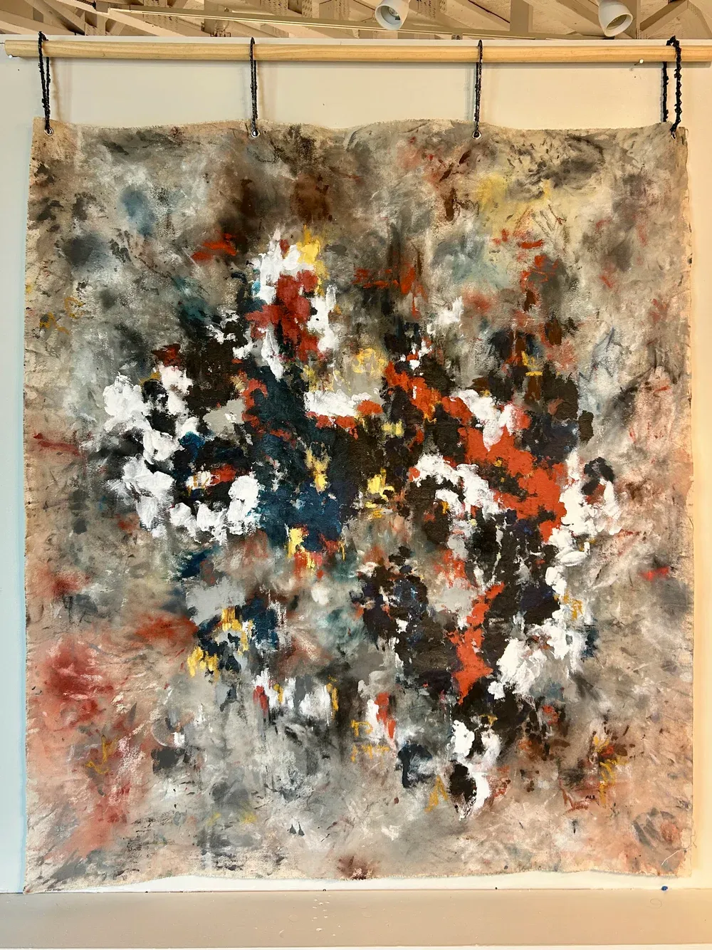 Painting called "The Purge" hung on wall with chainsaw chains.