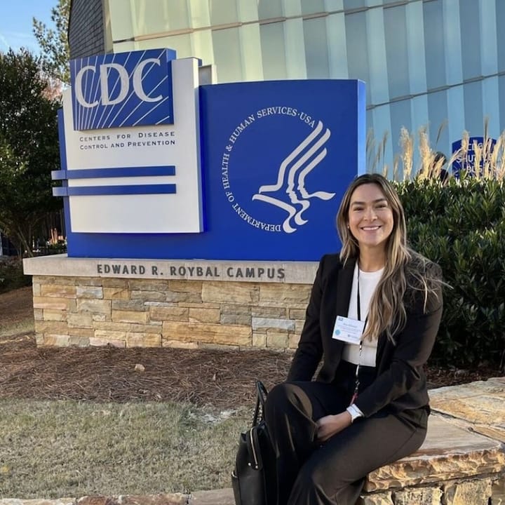 Photo of Dr. Ana Mitchell in front off the the Centers for Disease Control and Prevention, Edward R. Roybal Campus sign.